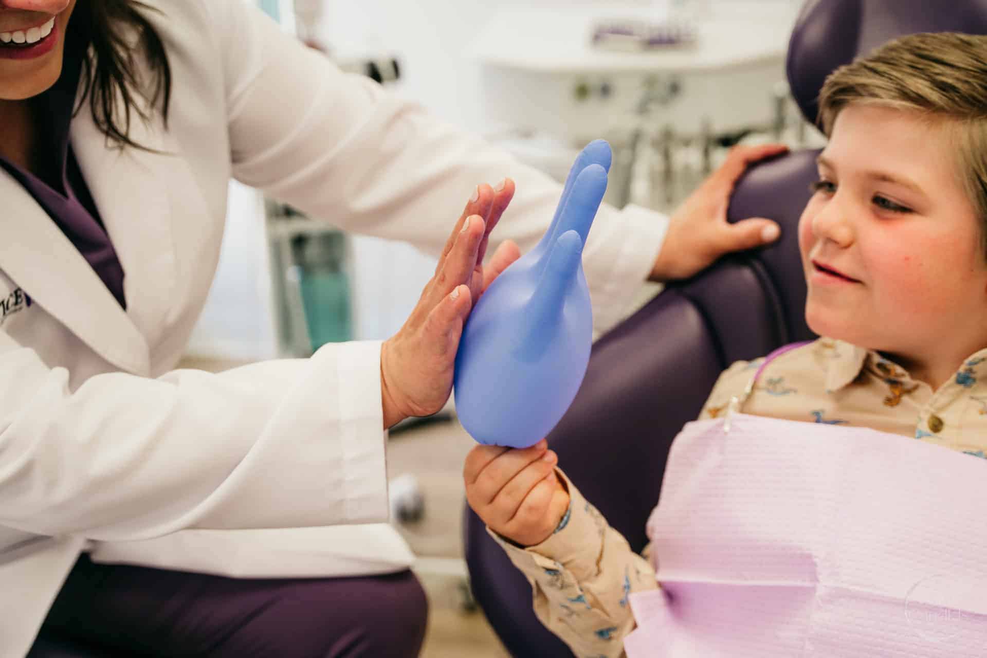 Dental hygienist using ergonomic tools during a procedure