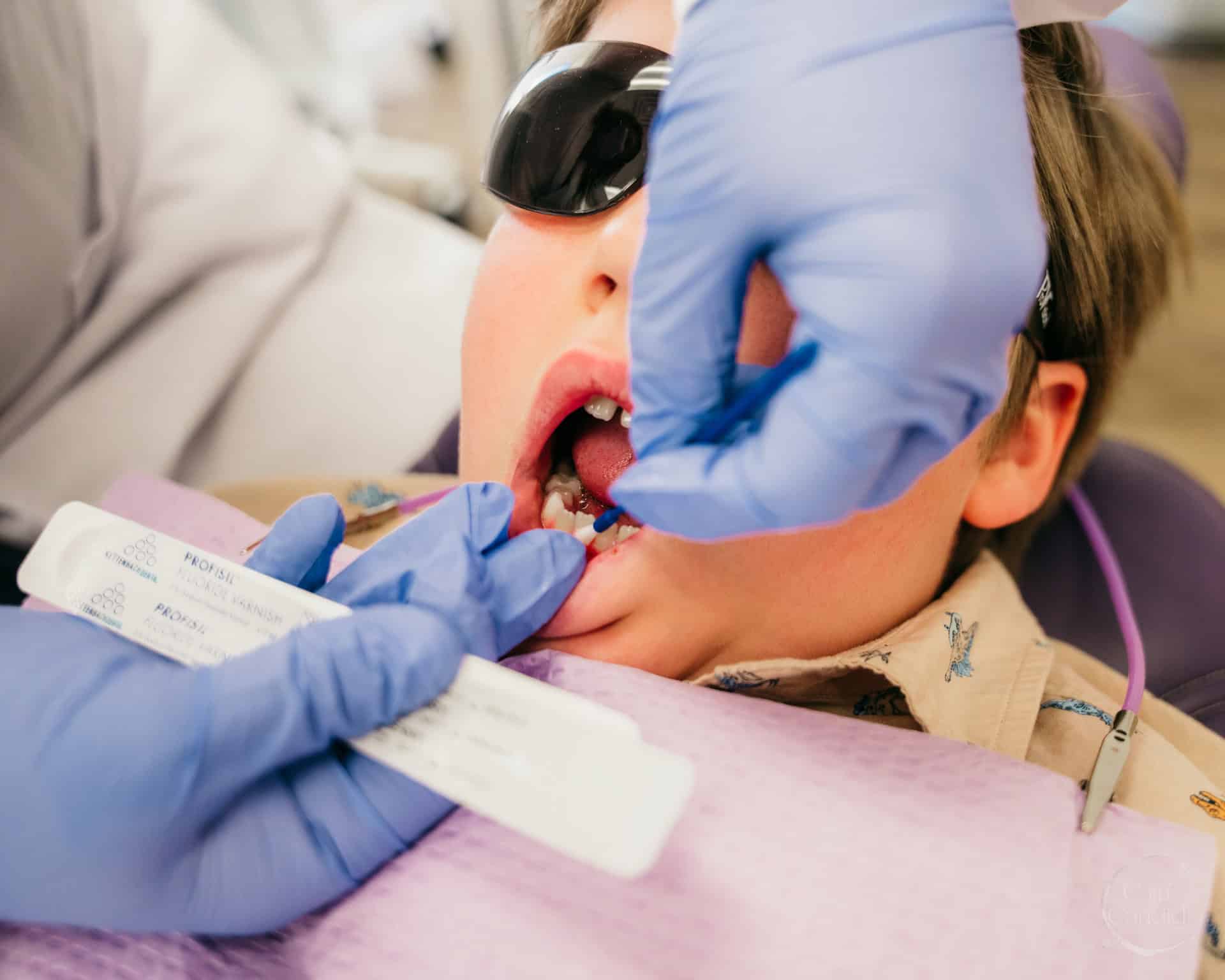 Dental hygienist providing care to a patient in a Colorado Springs clinic.