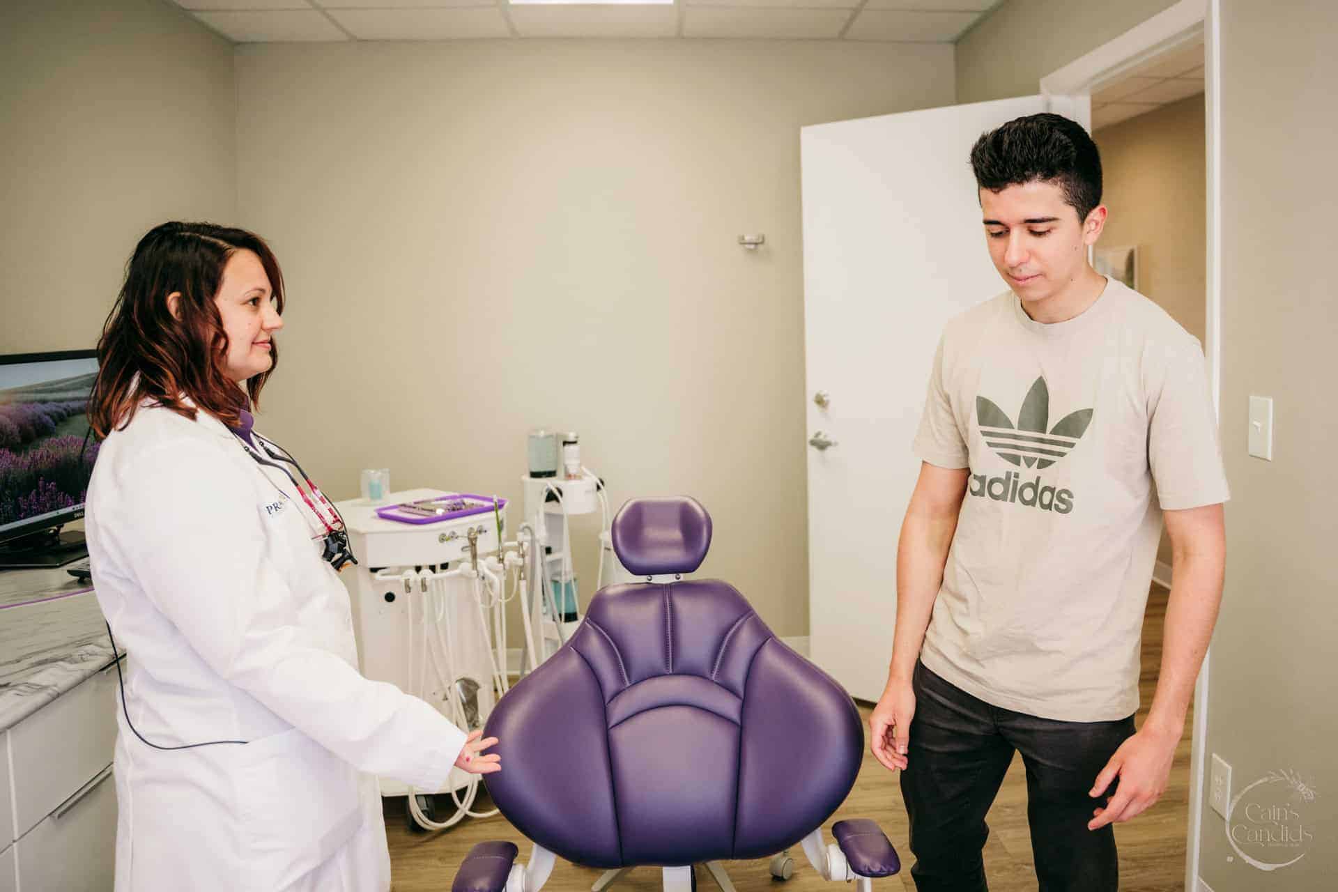 A dental hygienist educating a patient about oral health.