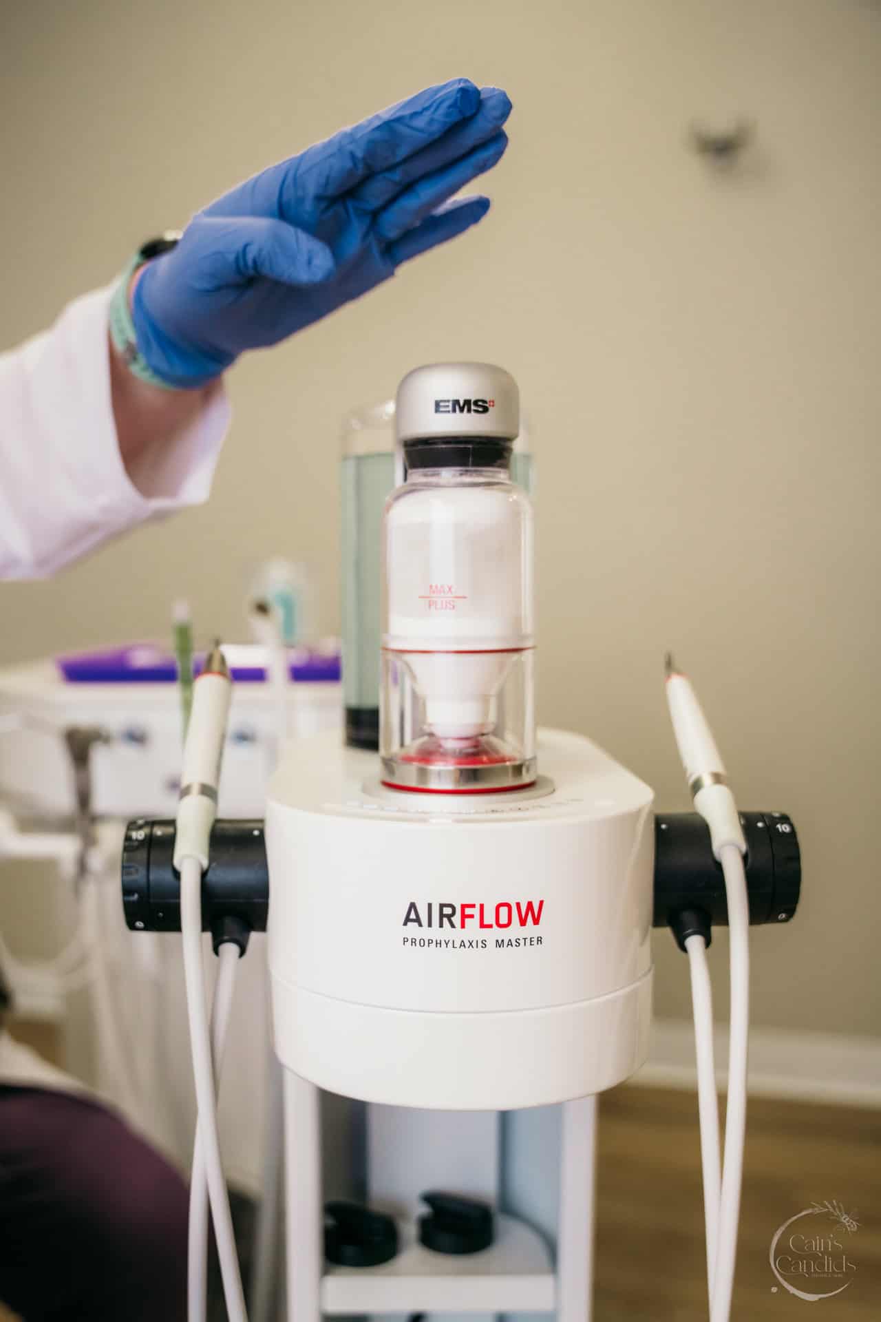 A dental professional washing hands with soap and running water