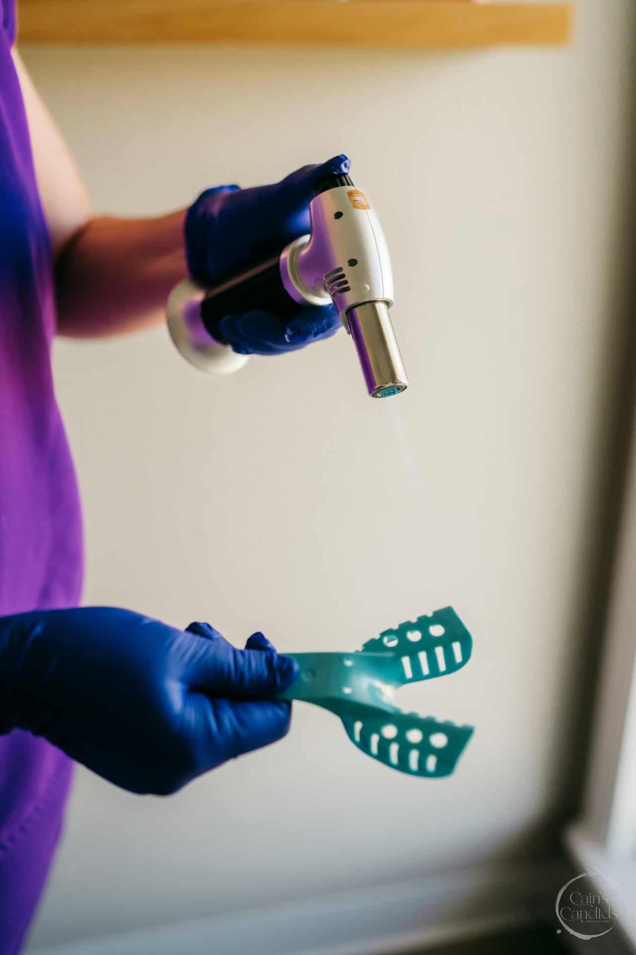 Dental hygienist examining a patient's oral cavity for signs of lupus.