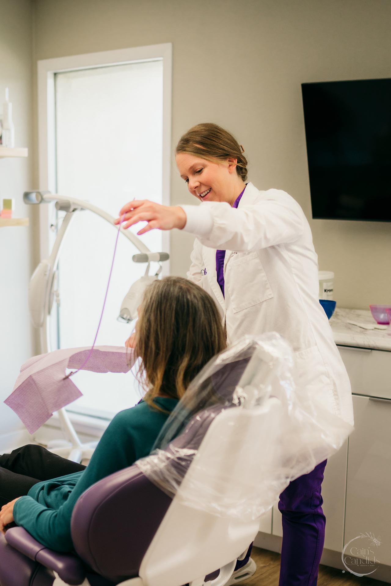 Dental hygienist performing coronal polishing on a patient